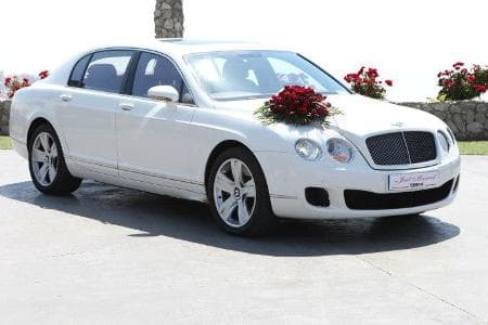Luxury Bentley GT decorated with red roses and green leaves