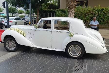 The side of the vintage Rolls-Royce Bentley parked next to stone pavement in Beirut Lebanon
