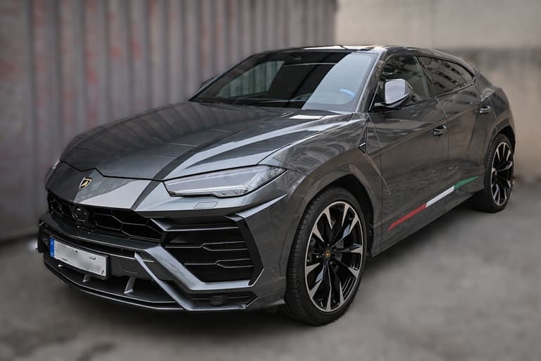 Luxury Lamborghini Urus color silver parked in Beirut parking showing front right